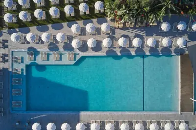 an overhead view of a swimming pool with chairs at Atlantica Sungarden Park in Ayia Napa
