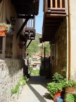 an alley with buildings and plants on the side at The Mill Hotel in Kakopetria