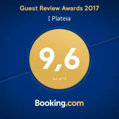a yellow circle with the words guest review awards at I Plateia in Kalopanayiotis