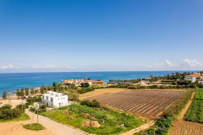 an aerial view of a farm and the ocean at Seaside Luxury Villa with Heated Pool in Paralimni