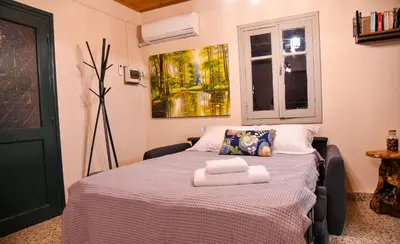 a bedroom with a bed with two towels on it at Sophias Cottage in Askas