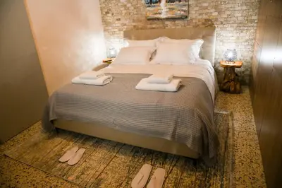 a bedroom with a bed with two towels on it at Sophias Cottage in Askas