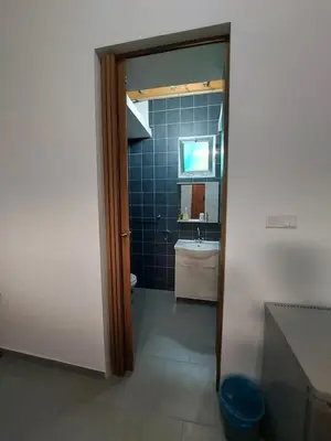a bathroom with a sink and a toilet and a mirror at Anna Guesthouse 10 min walk from the beach in Larnaka