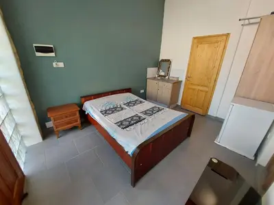 a bedroom with a bed and a wooden door at Anna Guesthouse 10 min walk from the beach in Larnaka