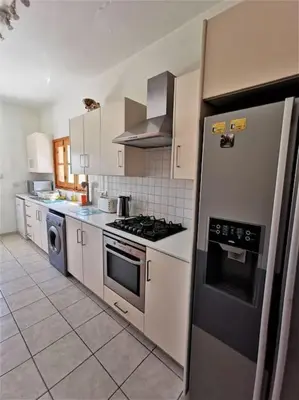 a kitchen with stainless steel appliances and white cabinets at Unique Stonehouse Traditional Villa in Ayia Anna in Ayia Anna