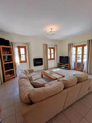 a large living room with a large couch at Unique Stonehouse Traditional Villa in Ayia Anna in Ayia Anna