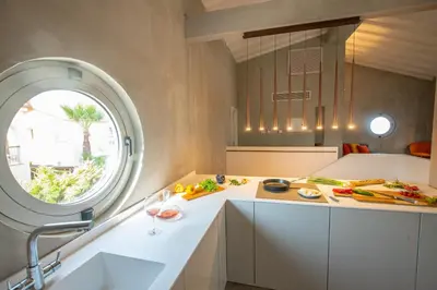 a kitchen with a counter with a sink and a window at Protaras Art House Seviews in Protaras