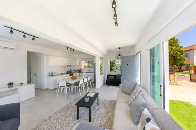 a living room and kitchen with a couch and a table at Ayia Napa Marina Vibes in Ayia Napa