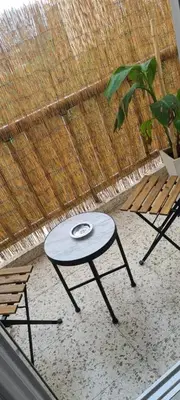 a table and two chairs in front of a window at Cozy Apartment by the sea in Limassol