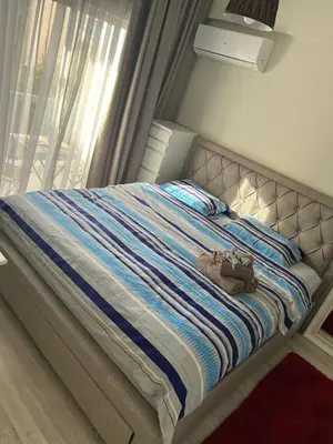 a bed with a pair of shoes sitting on it at Cozy Apartment by the sea in Limassol