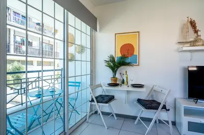 a room with a table and chairs next to a window at Sofia's Cosy Studio in Larnaca in Larnaka