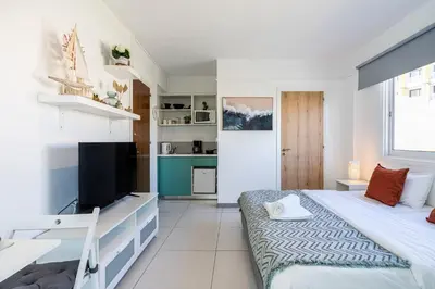 a bedroom with a bed and a television in it at Sofia's Cosy Studio in Larnaca in Larnaka