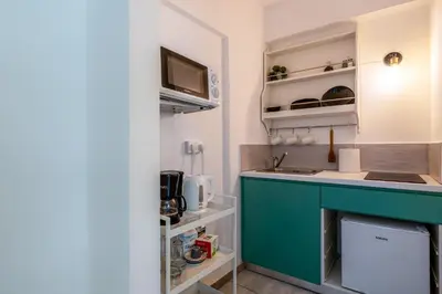 a small kitchen with a blue counter top at Mila's 1-BR Apartment in Larnaca in Larnaka