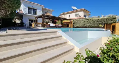 a villa with a swimming pool and a house at Villa del Mar Heated pool in Mazotos