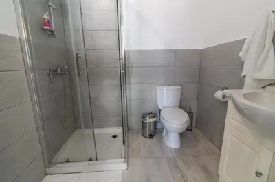 a bathroom with a shower and a toilet and a sink at Jana's 2-BR Apartment in Larnaca in Larnaka