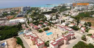 an aerial view of a city with a resort at NISSI BEACH AYIA NAPA Pool View Apartment Large Terrace 450m from Nissi Beach in Ayia Napa