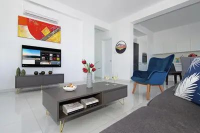 a living room with a couch and a table at Villa Theresa in Protaras