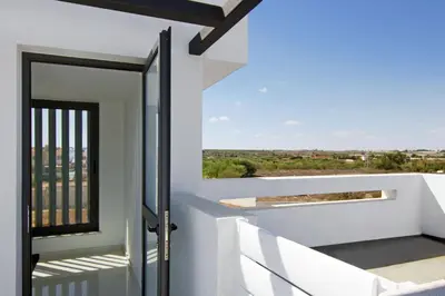 a view from the balcony of a house with a glass door at Villa Theresa in Protaras