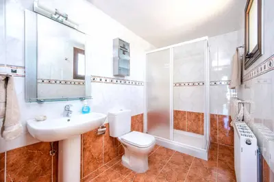a bathroom with a toilet and a sink and a shower at Amani Villa in Protaras