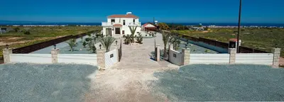 a stairway leading to a white building with a clock tower at Amani Villa in Protaras