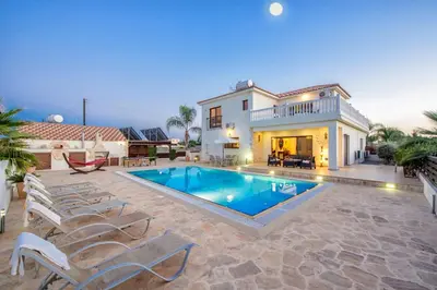 a villa with a swimming pool and a house at Amani Villa in Protaras