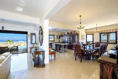 a large living room with a dining room and a kitchen at Amani Villa in Protaras