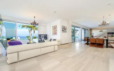a living room with a white couch and a table at Bay View Villa in Protaras