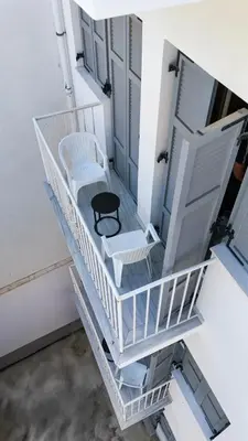 a stairway with two chairs and a chair on it at City Centre Studio Apartments Nicosia in Nicosia