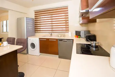 a kitchen with a sink and a washing machine at Villa Athena in Protaras