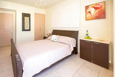 a bedroom with a bed and a dresser at Villa Athena in Protaras