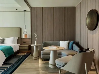 a bedroom with a bed and a table and a chair at City of Dreams Mediterranean - Integrated Resort, Casino & Entertainment in Limassol