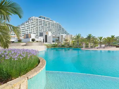 a large swimming pool in front of a hotel at City of Dreams Mediterranean - Integrated Resort, Casino & Entertainment in Limassol