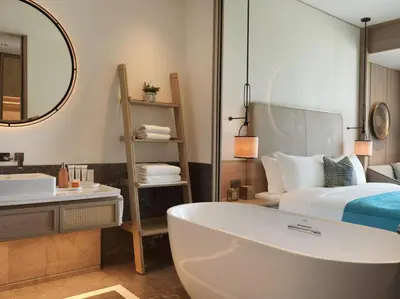 a bathroom with a tub and a bed and a mirror at City of Dreams Mediterranean - Integrated Resort, Casino & Entertainment in Limassol