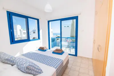 a bedroom with a bed and a balcony at Villa Saint Nikolas in Protaras
