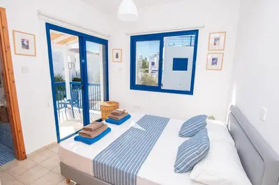 a bedroom with a bed with two towels on it at Villa Saint Nikolas in Protaras