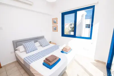 a bedroom with a bed and a window at Villa Saint Nikolas in Protaras