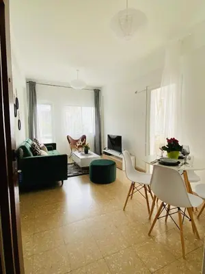 a living room with a couch and a table and chairs at Boho-Chic one bedroom flat in Engomi in Engomi