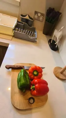 a cutting board with peppers and a knife on a counter at STAY Downtown Retreat in Limassol