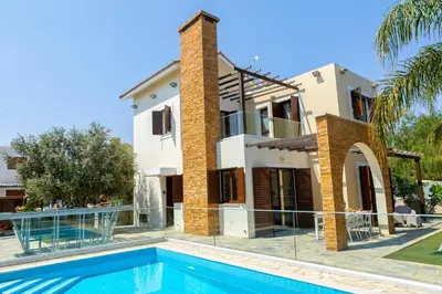 a house with a swimming pool in front of it at Ayia Napa Ionion Seaside Villa in Ayia Napa