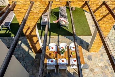 an overhead view of a wooden table with chairs at Ayia Napa Ionion Seaside Villa in Ayia Napa
