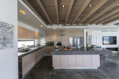 a large kitchen with a large island in the middle at Beachfront Dream Villa in Protaras