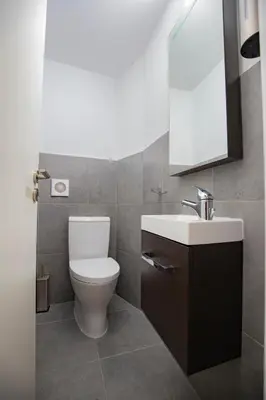 a bathroom with a toilet and a sink and a mirror at Arsos Nest in Arsos