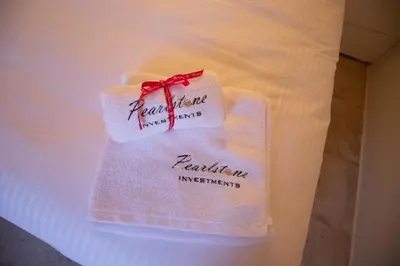 a towel with a red ribbon on a bed at Arsos Nest in Arsos