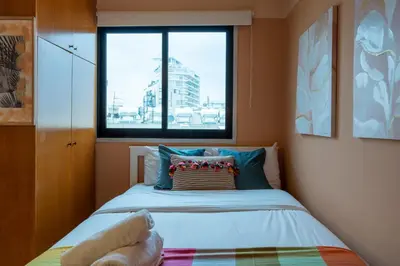 a small bedroom with a bed and a window at Johny's Spot in Larnaca in Larnaka
