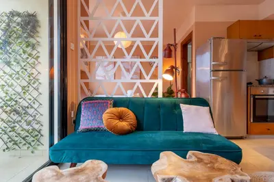 a living room with a green couch with a pumpkin on it at Johny's Spot in Larnaca in Larnaka