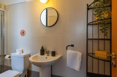 a bathroom with a sink and a toilet and a mirror at Johny's Spot in Larnaca in Larnaka