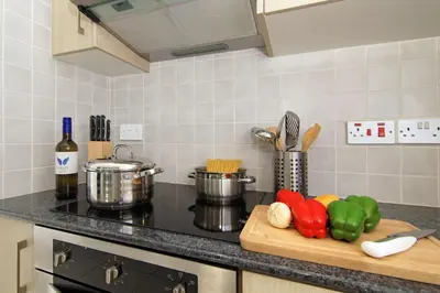 a kitchen counter with vegetables on a cutting board at Villa Nissinia - Nissi Beach Area in Ayia Napa