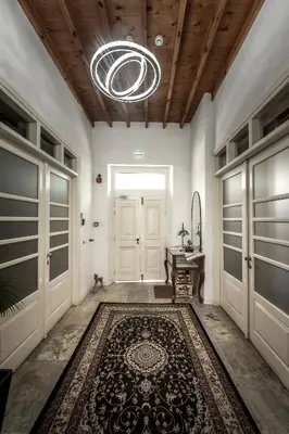 a hallway with a door and a rug on the floor at Edem Traditional House in Larnaka