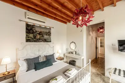a bedroom with a white bed and a chandelier at Edem Traditional House in Larnaka