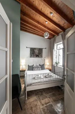 a bedroom with a bed and a wooden ceiling at Edem Traditional House in Larnaka